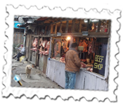 Butcher's shop, Darjeeling. The dog seems impressed...